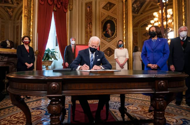 Biden got to work as he arrived in the Oval Office (Credit: PA) 