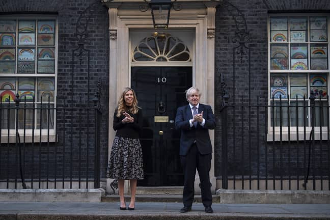 Boris Johnson and his partner Carrie Symonds outside 10 Downing Street in London, joined in the applause to salute local heroes during the nationwide Clap for Carers (Credit: PA)