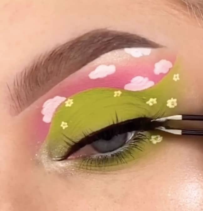 Next, she paints on tiny clouds and flowers before finishing with mascara and lashes (Credit: Adele Natalie)