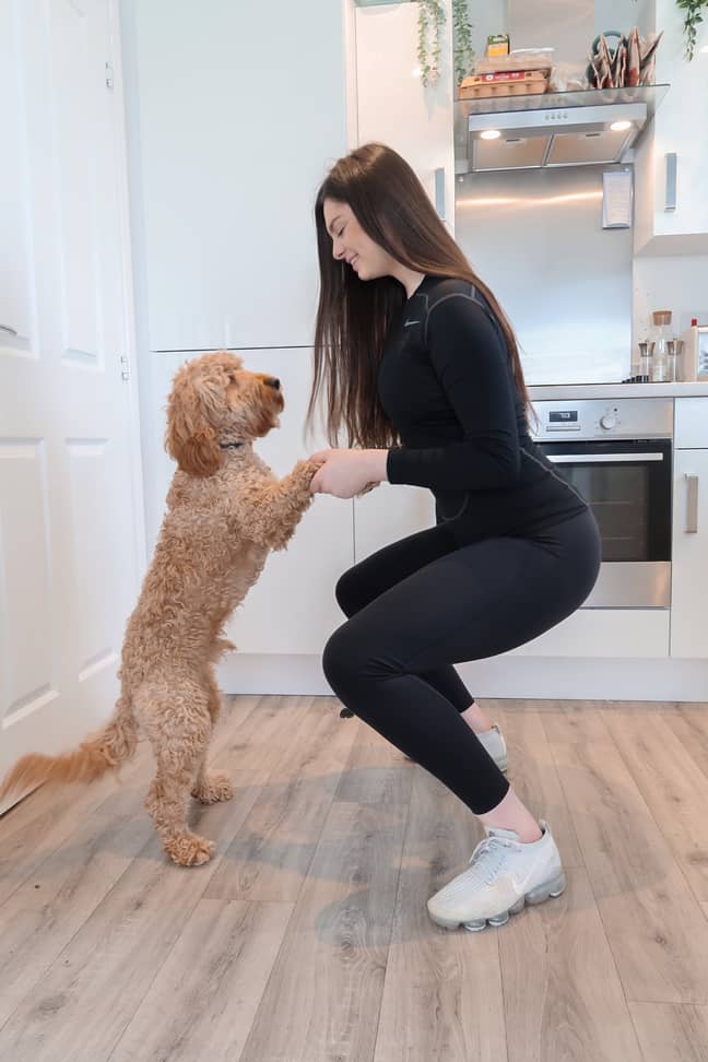 Squat whilst holding both your dog's paws so they are on their hind legs for added resistance, says Amy (Credit: Canine Cottages/Amy Lou Perry)